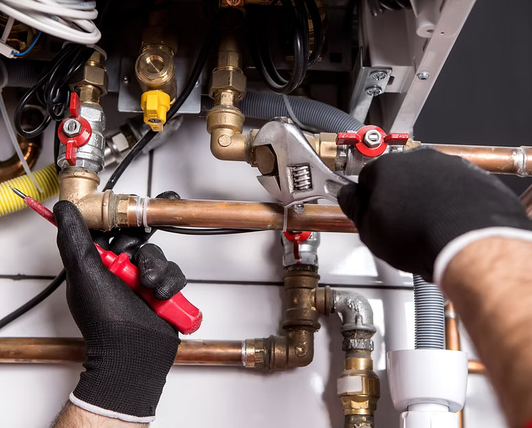Plumber working on copper pipes